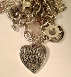 a bunch of charms that are sitting on a white counter top with the words averia special daughter written on them