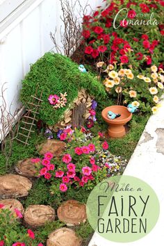 a small garden with flowers and plants in the ground next to a house made out of logs