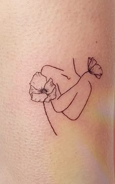 a woman with a flower tattoo on her thigh