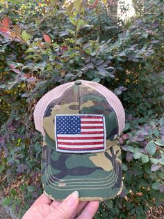 Description "American Flag USA" Vintage Distressed Trucker Cap Color: Camo Distressed Material: Cotton/Polyester blend, Mesh backSize: One size fits most, with an adjustable snapback. Unisex cap. Distressed Snapback Hat For Outdoor, Distressed Snapback Dad Hat For Outdoor, Adjustable Trucker Hat Made In Usa, Distressed Adjustable Trucker Hat For Outdoor, Casual Trucker Hat Baseball Cap Made In Usa, Snapback Hat Made In Usa, Casual Adjustable Trucker Hat Made In Usa, American Style Adjustable Trucker Hat For Memorial Day, Adjustable Trucker Hat For Memorial Day