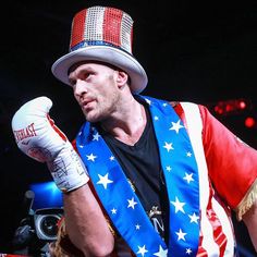 a man wearing an american flag outfit and boxing gloves with his hand on his fist