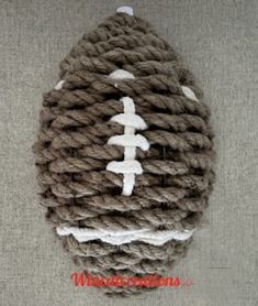 a knitted football ornament is shown on the floor