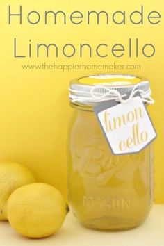 two lemons next to a jar of lemonade with the words homemade limoncello on it