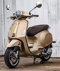 a tan scooter parked in front of a building