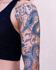 a woman with a dragon tattoo on her arm