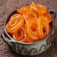 a bowl filled with sliced oranges on top of a table