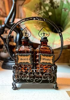 two brown bottles sitting on top of a metal stand