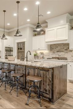 a large kitchen with an island and bar stools