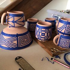 some pottery is sitting on a table with scissors