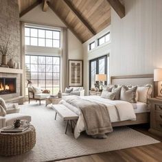 a bedroom with a large bed and fireplace in it