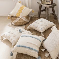 pillows and blankets on the floor in front of a window