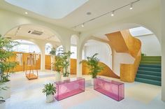 the interior of an office building with planters and plants in it's center