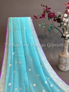 Sky blue and Purple Banarasi Chiffon Silk Saree and Blouse. Capture the captivating beauty of the season with this exclusive Sky blue and Purple Banarasi Chiffon Silk Saree and Blouse. This intricate garment is sure to make a statement of sophistication and luxury. Perfect for special occasions or everyday, add this piece to your wardrobe and experience the elegance and beauty of the highest quality. Designer Blue Blouse Piece With Zari Weaving, Blue Chanderi Blouse Piece With Pallu Detail, Unstitched Light Blue Traditional Wear With Self Design, Blue Georgette Traditional Wear With Pallu, Blue Georgette Traditional Wear With Pallu Detail, Designer Blue Saree With Cutdana Detailing, Light Blue Chanderi Saree With Zari Work, Light Blue Chanderi Traditional Wear With Pallu, Designer Turquoise Georgette Dupatta