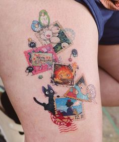 a woman's thigh with tattoos on her legs and various pictures painted on it