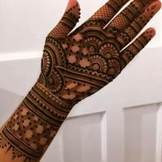 the hand is decorated with henna designs on it's fingers and hands are shown