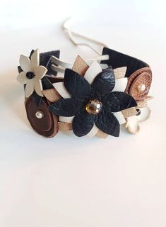 a close up of a bracelet with flowers on it