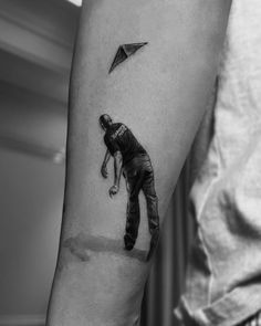 a man with a kite tattoo on his arm