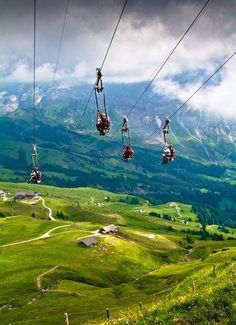 two people ride on the gondola with mountains in the background and text that reads go ziplining