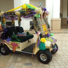 a golf cart decorated with mardi gras decorations