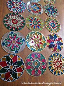 many different colored glass plates sitting on top of a wooden table