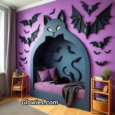 a bedroom with purple walls and bats on the wall