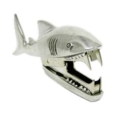 a shark shaped metal object with teeth on it's head and mouth, in the shape