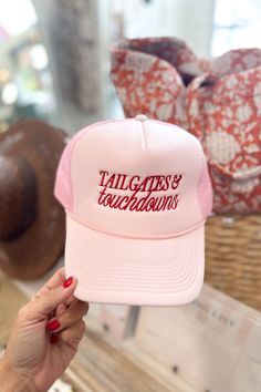 Our Tailgates & Touchdowns Trucker Hat is a must have for gameday! Pink snapback hat with Red graphic. Terrycloth lining for a comfort fit. Perfect for everyday! 100% Polyester font, 100% Nylon Mesh Back ALL ACCESSORIES ARE FINAL SALE! Feel free to email us at info@emersoncharles.com or DM us with any questions regarding fit, styling, or our return policy in general. Nashville Trucker Hat, Hat Flatlay, Gods Country, Trucker Hat Fashion, Pink Cowboy, Custom Trucker Hats, Denim Sweater, Top Graphic Tees, Dress Gift