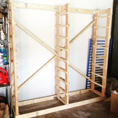 an unfinished room with shelves and tools on the floor in front of a white wall