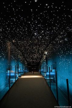 a long hallway with stars on the ceiling and lights in the ceiling, all lit up