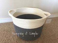 a black and white basket sitting on the floor