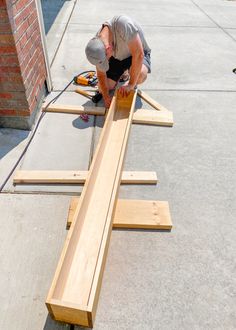 a man is working on some wooden planks