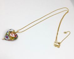 "What a lovely way to show your love to someone by giving them a gorgeous handmade glass heart. This Venetian Murano glass heart is sourced straight from the artisans of Venice, Italy. The techniques used to make these glass beads are hundreds of years in the making. The gold bead has genuine 14k gold foil within the glass. It is then hand painted with a unique color and design on each side of the heart. I have taken this bead and added 2 small gold plated beads to accent the heart and then it h Multicolor Heart Necklace For Gift, Elegant Multicolor Heart Necklace For Valentine's Day, Elegant Multicolor Heart Necklace For Gift, Elegant Multicolor Heart Necklace Gift, Glass Heart Pendant Necklace For Gift, Valentines Day Jewelry, Heart Pendant Necklace Gold, Murano Glass Earrings, Heavy Earrings