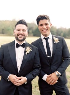 two men in tuxedos standing next to each other