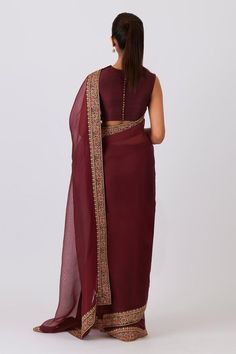 Mulberry marron saree with floral aari and zardozi borders flecked in gold and swarovski crystals. Comes with unstitched blouse piece.
Components: 2
Type Of Work: Floral
Fabric: Silk Organza
Color: Maroon
Other Details: 
Border detailing
Note: The stitched blouse worn by the model is not for sale
Occasion: Puja - Aza Fashions Formal Art Silk Choli With Zari Work, Formal Blouse Piece With Resham Embroidery For Navratri, Formal Resham Embroidery Blouse Piece For Navratri, Formal Pre-draped Resham Embroidery Saree For Navratri, Formal Art Silk Choli With Cutdana, Diwali Formal Blouse Piece With Resham Embroidery, Formal Saree With Resham Embroidery For Navratri, Formal Diwali Blouse Piece With Resham Embroidery, Formal Blouse Piece With Resham Embroidery For Diwali