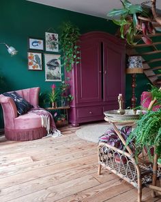 a living room filled with furniture and lots of plants