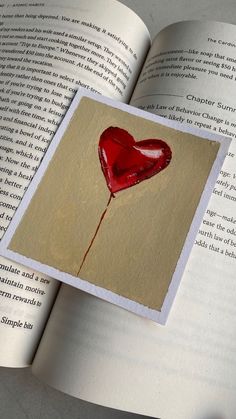 an open book with a red heart on it