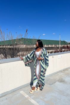 Rich Auntie at it's finest! Our fashion satin kimono can be worn as an oversized dress on it's own or cinched at the waist for a more fitted look. Flowy and colorful style definitely can make this a beach coverup or vacation look. In One Size fits up to size 3X. as the sleeves are open flowy and the kimonos have an open front. Styling tip: Pairs perfectly with our Summertime Maxis, T Shirt Maxis and strapless smocked rompers. Size US Size One Size Oversized Green Kimono For Spring, Green Oversized Kimono For Spring, Oversized Green Spring Kimono, Green Spring Vacation Robe, Spring Vacation Green Robe, Green Kimono For Fall Vacation, Green V-neck Kimono For Fall, Chic Long Sleeve Green Kimono, Chic Green Long Sleeve Kimono