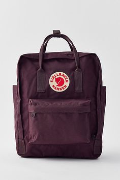 Lightweight coated canvas backpack from Fjallraven with a wraparound zip closure and an interior envelope pocket for toting your tablet. Topped with an additional zip pocket at the front and adjustable, webbed straps at the back. Double carry handles along the top. Content + Care PVA, polypropylene, mixed metal Spot clean Imported Size Dimensions: 10.62" l x 5.11" w x 14.96" h | Fjallraven Kånken Backpack in Dark Purple, Women's at Urban Outfitters