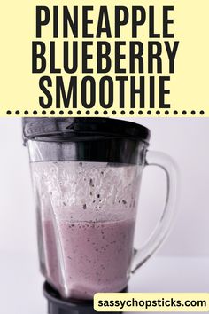 a pink smoothie in a blender with the words pineapple blueberry smoothie