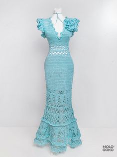 a crocheted dress is displayed on a mannequin