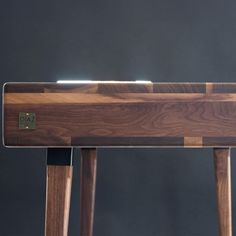 a close up of a wooden table with a metal object on it's side