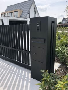 a house with a black fence and white walls