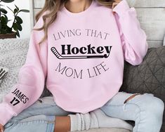 Are you looking for Custom Hockey Mama Sweatshirt? We got you! ✅ ABOUT OUR  Hockey Mom Hoodie Crewneck ▸  These garments are made from polyester and cotton.  ▸ The collar is ribbed knit, so it retains its shape even after washing.  ▸ There are no itchy side seams on these sweaters. ▸Printed and shipped from the USA ▸ Shipped in a safe package to ensure it arrives perfect. GUARANTEED. ✅ HOW TO ORDER your Sweatshirt for Mom 1. Check our photos for sizing and color options. 📏 2. Choose your quanti Hockey Mom Outfit, Hockey Mom Outfit Style, Hockey Mom Gifts, Hockey Hoodie, Hockey Sweatshirts, Mom Outfit, Hockey Gifts, Mom Hoodies, Hockey Mom