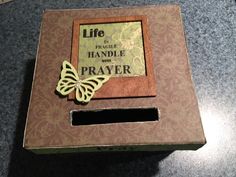 an open box with a butterfly on it and a quote in the middle that reads life is fragile, handle with prayer