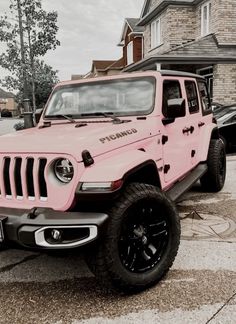 a pink jeep parked in front of a house