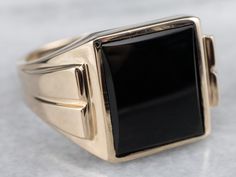 This vintage men's ring is stylish black onyx and yellow gold, a combination that is sophisticated and traditional. The design of this ring offers a little more size and substance but is still easy to wear. It sits flush to the hand and will be a great style piece for any man!Metal: 10K Yellow GoldGem: Black OnyxGem Measurements: 14.0 x 11.7 mm, RectangleRing Size: 12.50Marks: "10K B&F" Stamped on the inside band Classic Onyx Signet Ring With Polished Finish, Timeless Onyx Signet Ring With Polished Finish, Classic Onyx Signet Ring With Black Enamel, Timeless Black Enamel Signet Ring For Formal Occasions, Classic Black Signet Ring With Polished Edges, Black Polished Signet Ring For Formal Occasions, Classic Black Enamel Signet Ring, Classic Black Enamel Signet Ring For Formal Occasions, Classic Yellow Gold Onyx Rings