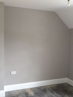 an empty room with gray walls and white trim