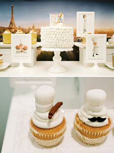 two cupcakes with white frosting on top and an image of the eiffel tower in the background