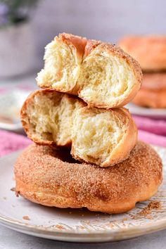 a stack of doughnuts sitting on top of a plate next to each other