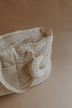 a white purse sitting on top of a table